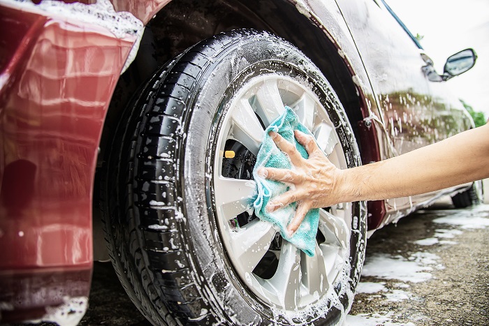 Man wash car using shampoo - every day life car care concept